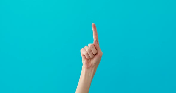 Woman Hand Points Down By Elegant Finger on Turquoise
