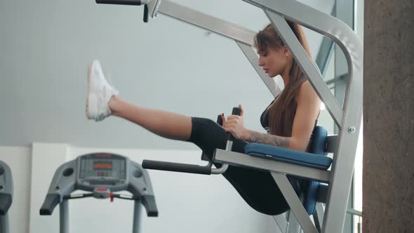 Well Trained Young Girl and Woman Training Abdominal Muscles Doing Sit Ups in Gym