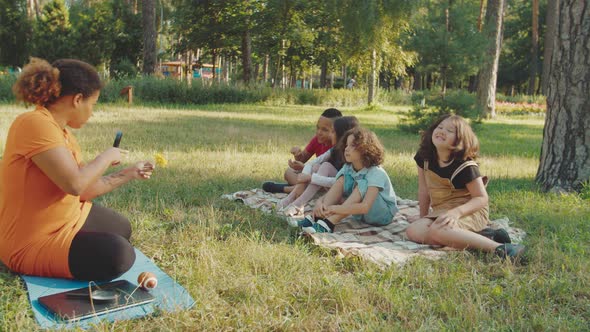 Curly Schoolkid Lost in Contemplation While Biology Lesson Outdoors