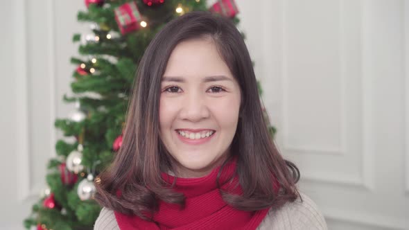 Cheerful happy young Asian woman smiling to camera in Christmas Festival. 