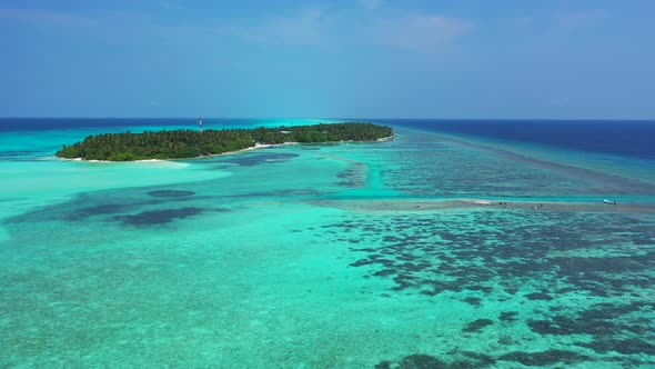 Wide angle birds eye abstract view of a paradise sunny white sand beach and blue water background 