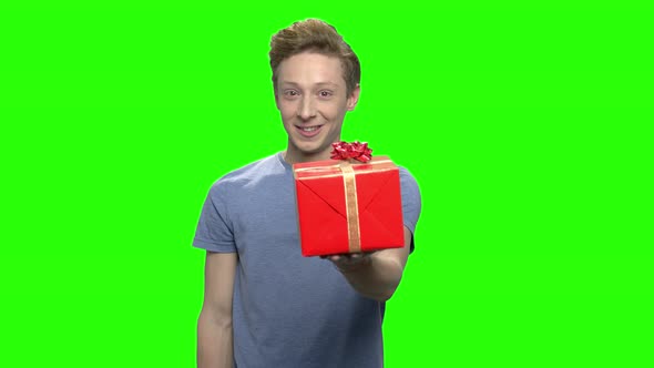 Teenage Boy with Gift Box and Thumb Up