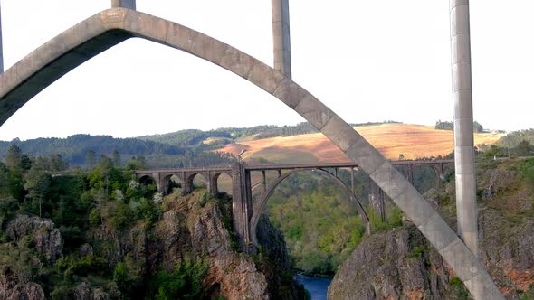 Drone Flying Underneath The New Ulla Viaduct With Old Gundian Bridge In Background In Galicia.