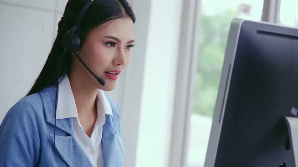 Customer Support Agent or Call Center with Headset Talking to Customer on Phone