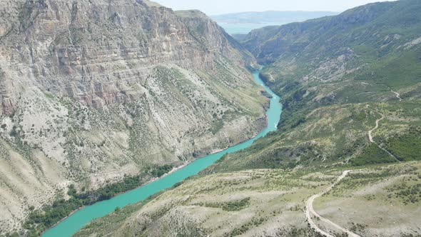 Drone Flight Over the Sulak Canyon a Long Blue River Below with Boats