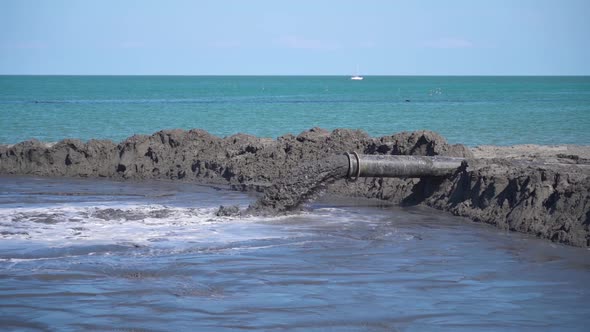 Mud Flows in Slow Motion Out of a Tube on the Beach