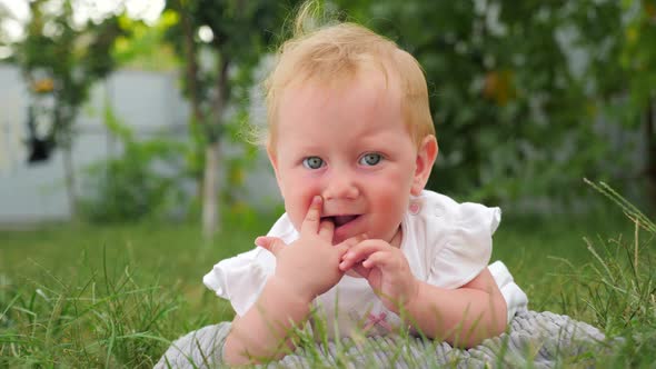 Baby teething background. Teeth are cutting through. Baby teething problems. Finger in mouth.