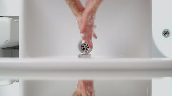 Female Hands Washing In Basin. Hygiene during coronavirus. A woman washes her hands