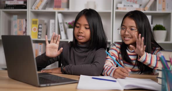 Two girls learning online at home