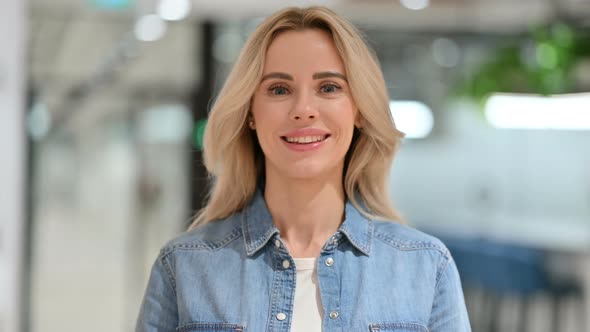 Young Casual Woman with Yes Sign By Shaking Head 