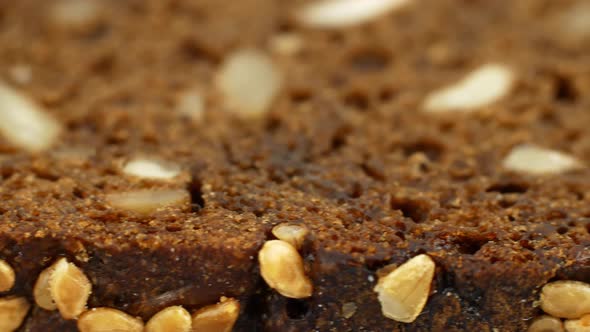 Slider video of a slice of whole-grain dark bread. Vegan diet food.