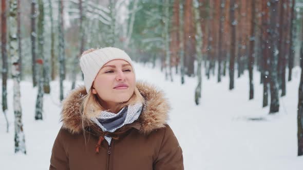 Snowing in Forest Woman in Winter Clothes Walking and Admiring the Nature