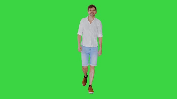 Casual Young Man Walking and Looking Forward on a Green Screen, Chroma Key