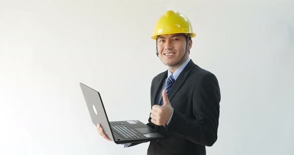 Male Architect Working With Laptop Computer And Thumb Up