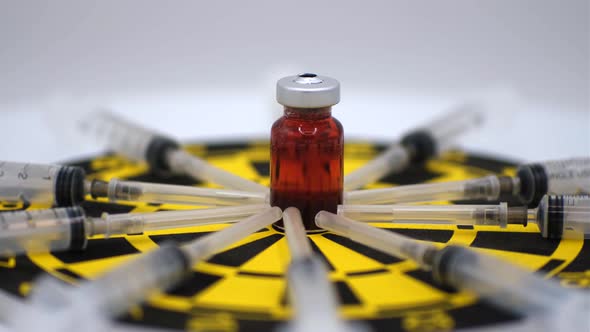 Vaccine bottle with red solution with syringe