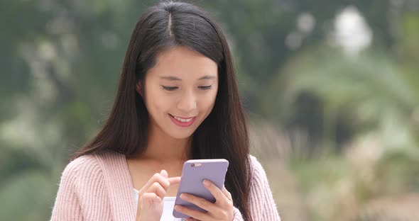 Woman using mobile phone at outdoor