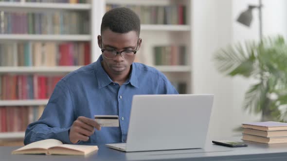 Young African Man Having Online Payment Problems on Laptop