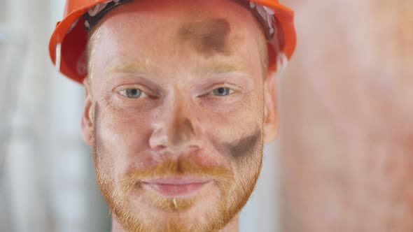 Portrait of Male Construction Worker on Building Site Wearing Hard Hat