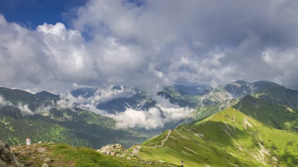 Green valley and Kasprowy Wierch in sunny day with clouds, Poland, timelapse, 4K