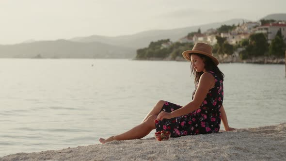 A Girl Eats Strawberries While Resting By the Sea