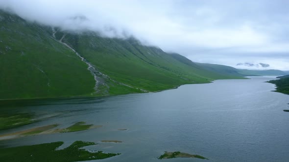 Pan right of Glen Etive water and mountain peaks in cloud cover