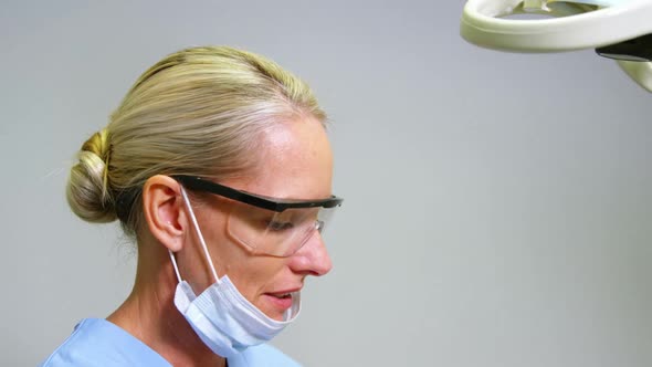 Female dentist assisting male patient to wear virtual reality headset