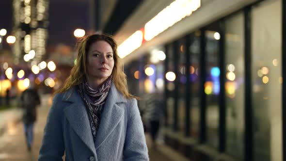 Elegant Stunning Woman in Light Blue Coat is Walking Alone on City Street in Megapolis