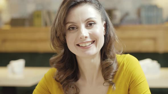 Closeup Portrait of Beautiful Caucasian Woman Looking at Camera Smiling