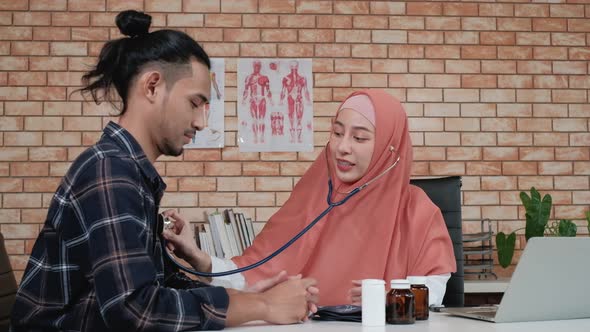 Young beautiful woman doctor is health examining a male patient.