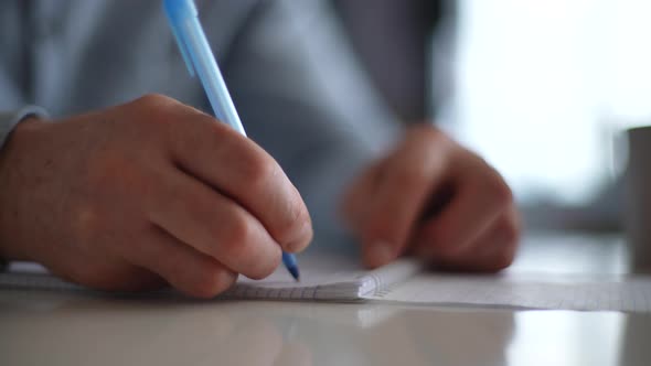 Closeup Hands of Unrecognizable Mature Adult Man Writing Making Notes in Organizer Book Keep