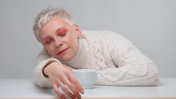 Blonde Woman with Short Haircut Wears Knitted Sweater