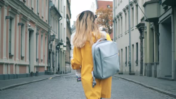 Girl with Map Walks on a Downtown Street.