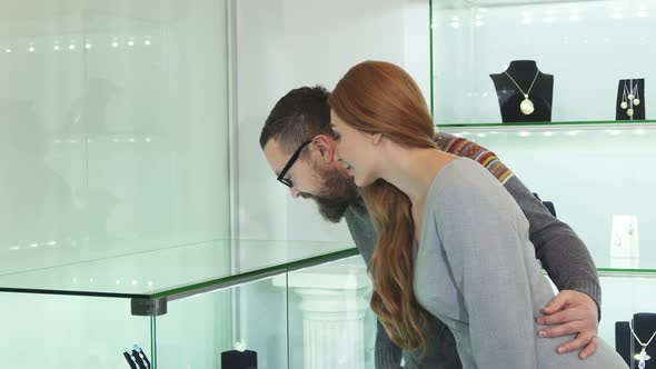 Beautiful Couple Choosing Jewelry at the Shopping Mall