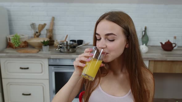 Lovely Girl Eating Raw Sprouts Buckwheat with Nuts in Kitchen with Fresh Vegetables and Fruits