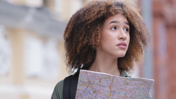 Confused Desperate Young Curlyhaired Black Student Girl Exploring Paper City Map Trying to Get