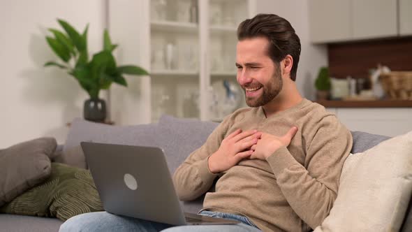 Cheerful Carefree Guy Using Laptop Computer for Video Connection