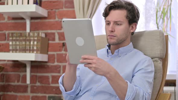 Ambitious Young Man Get Surprise on Tablet 