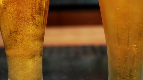 Close-up of two chilled glasses of beer