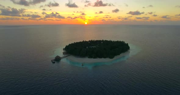 Aerial drone view of scenic tropical islands at sunset in the Maldives.