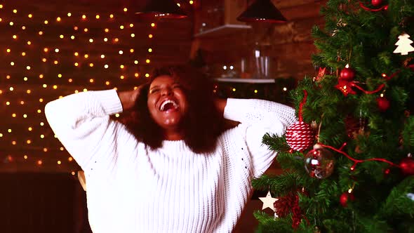 Spanish Happy Woman in White Sweater and Deer Horn Dancing and Singing in Living Room Alone