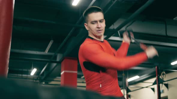 Male Athlete Is Using a Hammer During His Workout