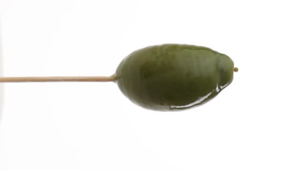 Vertical video: Canned olive on a stick rotates