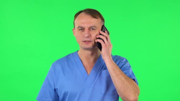 Medical Man Talking for Mobile Phone and Rejoice. Green Screen