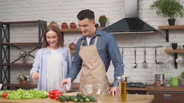 couple in love prepare ingredients in modern kitchen enjoy conversation and healthy vegetarian salad