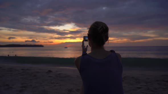 Slowmotion Shot of a Young Woman on a Beach Watching a Fantastic Sunset