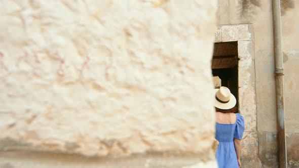 A young girl walking along the city street. Sibenik