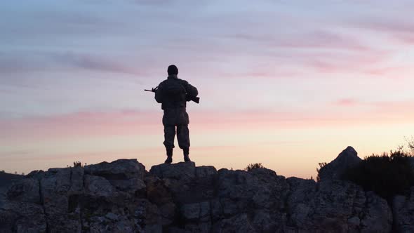 Soldier In The Morning Holds Guard With His Rifle