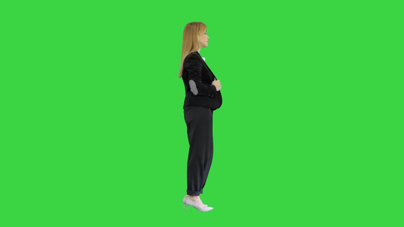 Pretty Blonde Woman Standing with Arms Crossed on a Green Screen, Chroma Key.