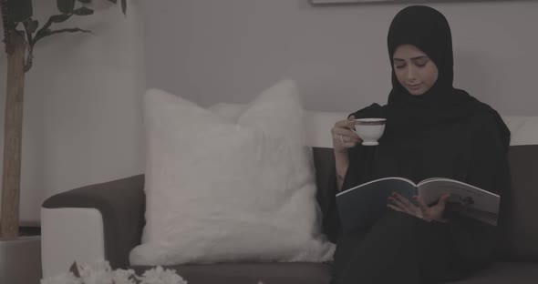 A Muslim Girl  Reading And Drinks Tea