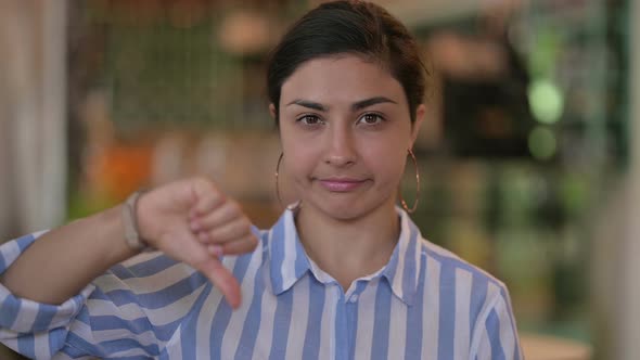 Disappointed Young Indian Woman Doing Thumbs Down 
